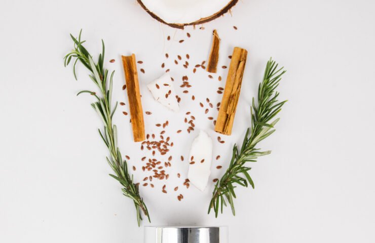 Müllwood Lasting Curl Cream jar flat lay with coconut, cinnamon, rosemary and flaxseed