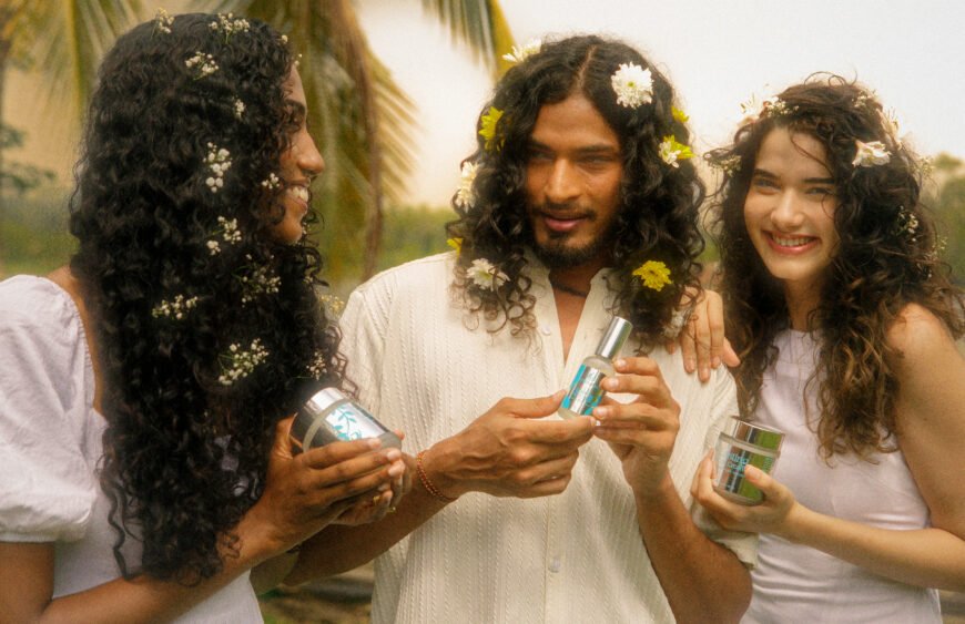 Three Sri Lankan models with curly hair and flowers holding Müllwood curl products outdoors